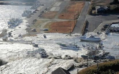 Boats are swept by a wave after a tsunami and earthquake in Asahikawa