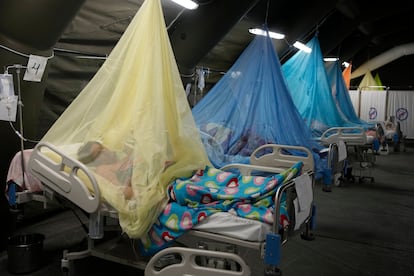 Patients suffering from dengue lie in beds in provisional tents at the Health Ministry in Piura, Peru, June 3, 2023.