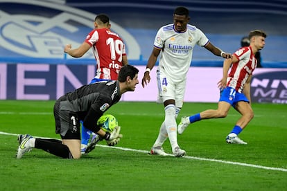 Real Madrid's Belgian goalkeeper Thibaut Courtois stops the ball during the Spanish league football match between Real Madrid CF and Club Atletico de Madrid at the Santiago Bernabeu stadium in Madrid on December 12, 2021. (Photo by JAVIER SORIANO / AFP)