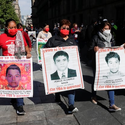 Luz Maria Telumbre, mother of Christian Alfonso Rodriguez Telumbre, one of the 43 missing students from  Ayotzinapa Rural Teachers' College, whose remains were found at the mountain town of Cocula, near Iguala in state of Guerrero, holds a poster with her son's picture while walking among other relatives as she arrives at the National Palace to attend a meeting with Mexico's President Andres Manuel Lopez Obrador in Mexico City Mexico July 10, 2020. REUTERS/Henry Romero