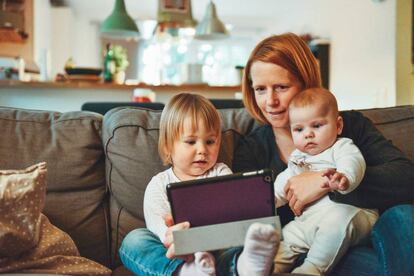 Una familia mira con atención una tableta. 