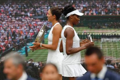 Garbiñe Muguruza y Venus Williams posan con sus trofeos para los fotógrafos tras la final de Wimbledon.