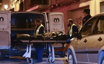 Medics remove the body of a woman killed in a gender violence case on January 22.