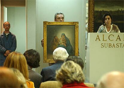El cuadro <i>Sagrada Familia,</i> de Goya, mostrado por un empleado de la casa de subastas.