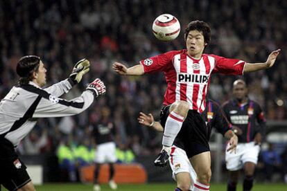 Coupet, portero del Olympique, intenta atrapar el balón ante Ji-Sung Pank.