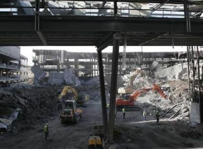 Trabajos de desescombro en el aparcamiento D de la terminal 4 de Barajas, destrozado por ETA.