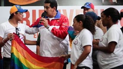 Nicol&aacute;s Maduro, holding a LGBT flag