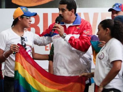 Nicol&aacute;s Maduro, holding a LGBT flag