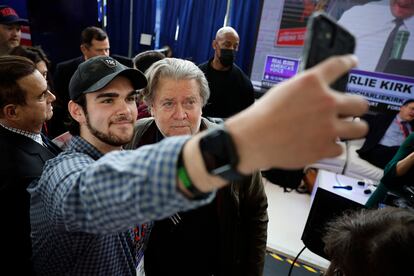 Steve Bannon, former advisor to former President Donald Trump and media executive, poses for selfies with supporters.