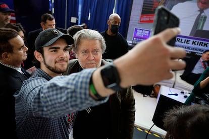 Steve Bannon, former advisor to former President Donald Trump and media executive, poses for selfies with supporters.