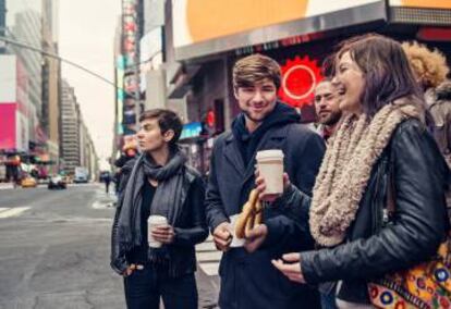 Jóvenes tomando café en un cruce de Times Square, en Nueva York.