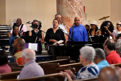 The Gesu Choir, standing, is cheered on by the congregation as they sing during Mass, on June 18, 2023, at Gesu Catholic Church in Detroit.