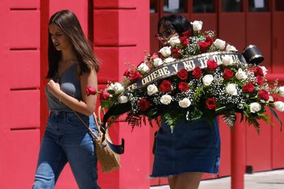 Una joven lleva una corona de flores para la capilla ardiente de José Antonio Reyes.