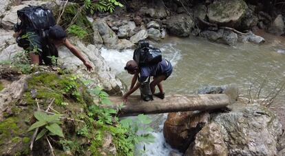 Refugees escaping the war in Myanmar help each other through perilous terrain to reach the Thai border.