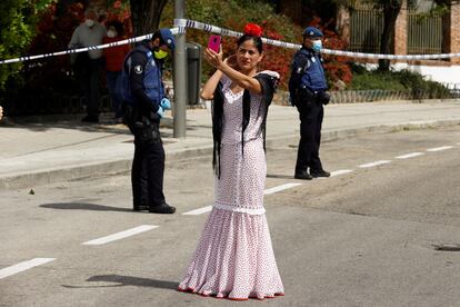 A woman dressed in traditional 'chulapa' dress observes the Day of San Isidro, the patron saint of Madrid, under security measures due to the coronavirus. 