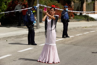 A woman dressed in traditional 'chulapa' dress observes the Day of San Isidro, the patron saint of Madrid, under security measures due to the coronavirus. 