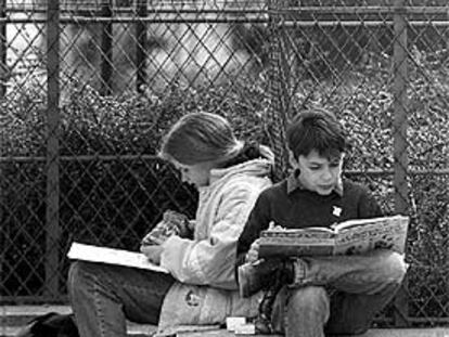 Dos alumnos estudian en un parque de París.