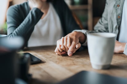 A couple holding hands.