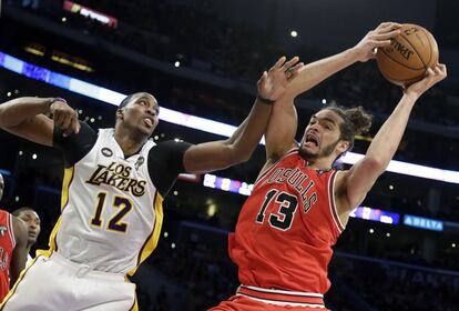 Joakim Noah, a la derecha, protege el balón ante Dwight Howard.