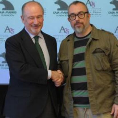 El presidente de Caja Madrid, Rodrigo Rato, y el director de la Academia, Álex de la Iglesia, en la presentación del acuerdo