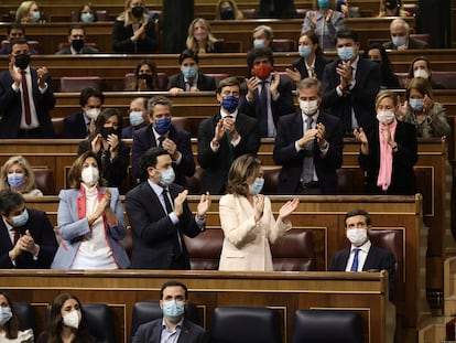 La portavoz del PP en el Congreso, Cuca Gamarra, acompañada de otros miembros del PP en el Congreso, aplauden al líder del PP, Pablo Casado, en la sesión plenaria del 23 de febrero de 2022, en Madrid (España).