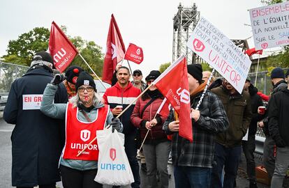 Striking St. Lawrence Seaway workers picket outside the St. Lambert Lock in St. Lambert, Quebec