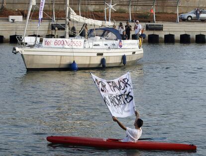 An anti-abortion protester holds a banner at the arrival of a boat belonging to the Dutch abortion organisation Women on Waves at the port of Valencia