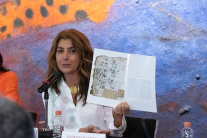 Historian María Castañeda de La Paz with a book of research on the Codices of San Andrés Tetepilco.