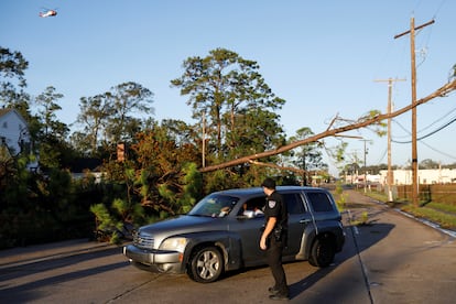 A police officer talks with a couple in a car after Hurricane Delta, in Jennings, Louisiana, U.S., October 10, 2020