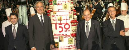 El presidente de Catalana Occidente Jose María Serra (2d) posa con los directivos de su empresa Francisco Arregui (dch.), Hugo Serra (izd.) e Iñaqui Álvarez junto a la tarta conmemorativa del 150 aniversario de la compañía.