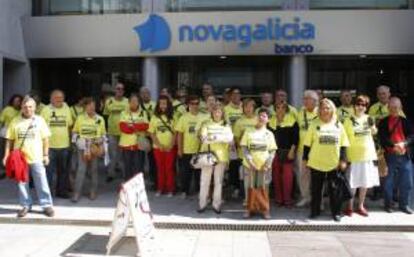 Afectados por participaciones preferentes protestan ante una sede de Novagalicia Banco. EFE/Archivo