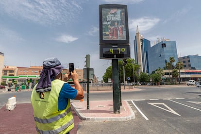 Un hombre fotografía un termómetro que marca 47 grados este miércoles en la Ronda de Levante de Murcia.