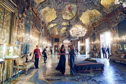 Visitantes paseando por la versallesca galería de espejos del Palazzo Valguarnera-Gangi.