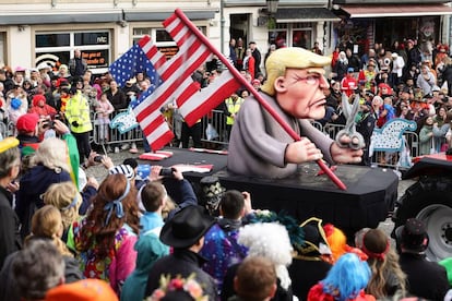 DUSSELDORF, GERMANY - FEBRUARY 12: A parade float shows an effigy of Donald Trump holding a pair of scissors in his hand with a cut-up US flag in the shape of a swastika at the annual Rose Monday Carnival parade on February 12, 2024 in Dusseldorf, Germany. The Mainz and Dusseldorf Rose Monday parades are known for their biting political satire. Cities in western Germany are celebrating the traditional Rhineland Carnival this week, culminating in today's Rose Monday parades. (Photo by Andreas Rentz/Getty Images)