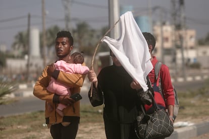 Una mujer sostiene una camiseta blanca a modo de bandera mientras huye de Ciudad de Gaza camino del sur del territorio, el 7 de noviembre de 2023. 