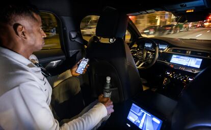 A user uses a Waymo autonomous (driverless) vehicle in downtown San Francisco (California, United States). Google's Waymo uses modified Jaguar vehicles. 