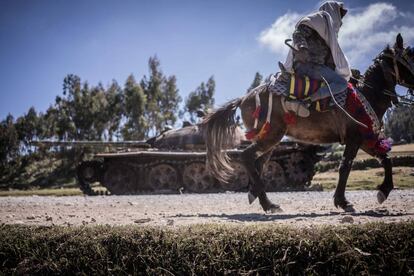 Un hombre montado a caballo pasa junto a los restos de un tanque eb Mesobit (Etiopía).