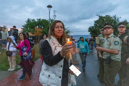 Una mujer con una vela, a orillas de lago Ranco, este martes tras el accidente del exmandatario.