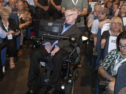 Stephen Hawking arrives onstage with Spanish police standing by.