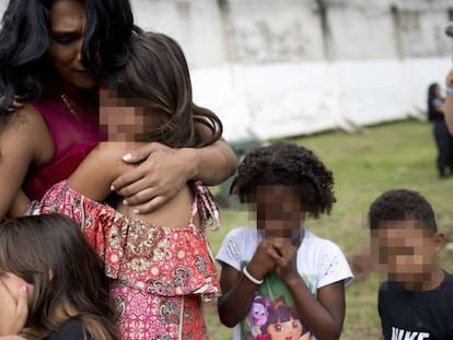 Uma mulher detenta com quatro de suas cinco crianças chora durante visita à Penitenciária Talavera Bruce no Rio de Janeiro, em 23 de Novembro de 2017.