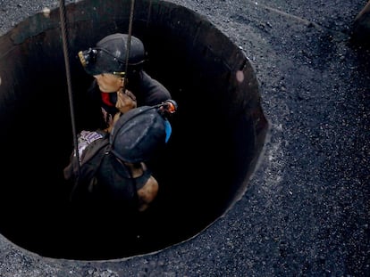 Dos obreros salen de una mina en Sabinas