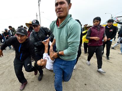 Men carry a fellow anti-government protester who was injured during clashed in Arequipa, Peru, Thursday, Jan. 19, 2023. Protesters are seeking immediate elections, President Dina Boluarte's resignation, the release of ousted President Pedro Castillo and justice for demonstrators killed in clashes with police. (AP Photo/Jose Sotomayor)