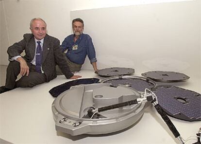 Los investigadores Ricardo Amils (derecha) y Luis Vázquez, junto a una maqueta de la sonda <i>Beagle 2. </i>