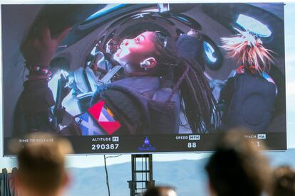 Guests watch a live broadcast from inside Virgin Galactic's rocket-powered plane Unity 22, showing space tourists Anastatia Mayers, 18, and her mother Keisha Schahaff, rear, at Spaceport America, near Truth or Consequences, N.M., Thursday, Aug. 10, 2023.