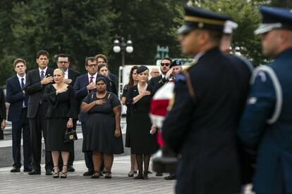 La familia de John McCain, en la primera fila y de izquierda a derecha, Meghan McCain, Bridget McCain y Cindy McCain, observa como el féretro con los restos mortales del senador es trasladado del Capitolio a la catedral de Washington.