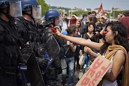 Una chica ofrece una flor a los policías durante una manifestación contra la reforma laboral prevista por el gobierno, en Lyon,Francia.