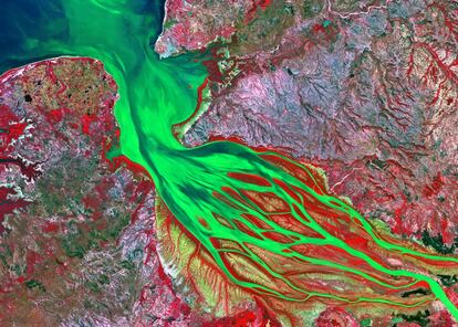 El río Betsiboka vierte sus rojizas aguas (de color verde en la foto) al Canal de Mozambique en la bahía de Bombetoka, en la costa oeste de Madagascar. Y en su desembocadura forma un estilizado estuario de alargadas islas, cubiertas parcialmente de manglares y acotadas por grandes bancos de arena generados, fruto de la gran cantidad de sedimentos que arrastra este cauce malgache.