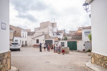 Grupo de personas se reúnen para hablar del incendio en la plaza de la iglesia de Casas de Moya.