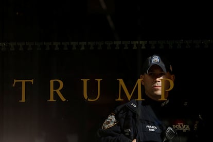 A police officer stands guard inside Trump Tower in Manhattan on Friday.