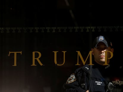 A police officer stands guard inside Trump Tower in Manhattan on Friday.